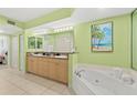 This bathroom features a granite countertop vanity and a soaking tub with a shower at 3315 S Atlantic Ave # 1406, Daytona Beach Shores, FL 32118