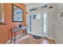 Bright foyer featuring tile flooring, modern console table, decorative mirror, and natural light at 37 Naranja Rd, Debary, FL 32713