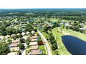 Aerial view of a community situated on a golf course with serene pond views at 438 Harbour Town Ln, Ormond Beach, FL 32174