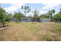View of the front of the home that has a large yard, mature landscaping and decorative blocks at 45 S University Cir, Deland, FL 32724
