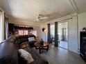Comfortable living room featuring a large sectional sofa, a ceiling fan, and access to the screened in porch at 487 Collins St, Ormond Beach, FL 32174