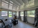 Bright sunroom featuring large windows, neutral flooring, and ample space for relaxation and enjoying the view at 487 Collins St, Ormond Beach, FL 32174