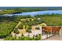 Expansive aerial view of a sprawling estate, showcasing the house and extensive property with equestrian barn at 5366 N Lake Farms Rd, De Leon Springs, FL 32130
