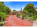 Single-story house with a red-paved driveway and mature trees at 558 Tulane Dr, Altamonte Springs, FL 32714