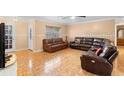 Spacious living room featuring tile floors and leather furniture at 558 Tulane Dr, Altamonte Springs, FL 32714