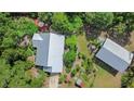 An aerial view shows a spacious property with lush landscaping and multiple structures at 5635 Burts Park Rd, De Leon Springs, FL 32130