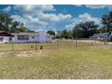 Expansive grassy yard surrounded by a chain-link fence, offering ample space for outdoor activities at 601 Berkshire Rd, Daytona Beach, FL 32114