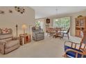 Spacious living area with a ceiling fan, tile floors and a combined dining area at 663 E Lansdowne Ave, Orange City, FL 32763