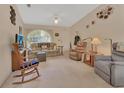 Inviting living room featuring comfortable seating, a ceiling fan, and a large window at 663 E Lansdowne Ave, Orange City, FL 32763