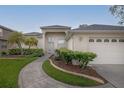 Welcoming single-story home with a well-kept lawn, garden beds, and an attached two-car garage at 723 Oakwater Ln, Port Orange, FL 32128