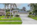 Charming single-story home featuring a well-maintained lawn, mature trees, and an attached two-car garage at 723 Oakwater Ln, Port Orange, FL 32128