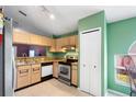 Functional kitchen with stainless steel appliances, bright green walls and ample cabinet space at 809 Brightview Dr, Lake Mary, FL 32746
