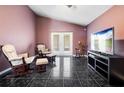 Cozy sitting room features French doors, comfortable seating and a television at 809 Brightview Dr, Lake Mary, FL 32746
