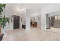 Bright entryway with updated flooring, stylish lighting, and open access to kitchen and dining spaces at 901 Vicksburg St, Deltona, FL 32725