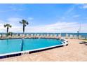 Sparkling pool with inviting lounge chairs and ocean view for luxurious relaxation at 915 Ocean Shore Blvd # 8010, Ormond Beach, FL 32176