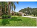 Beautiful brick home featuring mature trees, landscaping and a well-maintained lawn at 980 Marjorie Rawlings Dr, Deland, FL 32720