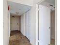 Entryway hallway featuring tiled floors, a utility closet, and access to the unit at 1 Oceans West Blvd # 2A1, Daytona Beach, FL 32118