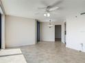 Spacious living room with tiled flooring, ceiling fan, and balcony access at 1 Oceans West Blvd # 2A1, Daytona Beach, FL 32118