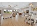 Bright and spacious living room with an open floor plan, wood floors, large windows, and contemporary decor at 1000 Megano Blvd, Deland, FL 32724