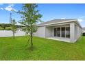 Inviting backyard featuring a covered patio and a large, green lawn, perfect for outdoor enjoyment at 1002 River Falls Cir, Deland, FL 32720