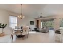 Open-concept dining area with tile floors, chandelier, and a seamless transition to outdoor living at 112 Chelsea Place Ave, Ormond Beach, FL 32174