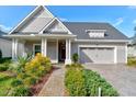 Attractive home featuring mature landscaping and a brick walkway leading to the front door at 112 Chelsea Place Ave, Ormond Beach, FL 32174