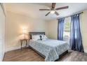 Cozy bedroom featuring wood-look floors, updated ceiling fan, and bright natural light at 1166 Tracy Dr, Port Orange, FL 32129