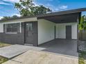 Spacious covered carport area with dual entry doors for added convenience and accessibility at 1203 W 20Th St, Sanford, FL 32771