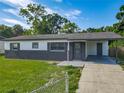 Well-maintained single-story house with a gray accent wall and a covered carport for convenient parking at 1203 W 20Th St, Sanford, FL 32771
