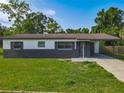 Inviting single-story home with gray brick accents, a carport, and a well-manicured front lawn at 1203 W 20Th St, Sanford, FL 32771