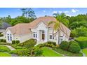Lovely single-story house featuring a tile roof, double-door entrance, and meticulously designed landscaping for added charm at 1324 Dovercourt Ln, Ormond Beach, FL 32174