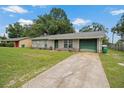 Charming single-story home with a well-maintained lawn, green door, and attached one car garage at 137 Fort Smith Blvd, Deltona, FL 32738