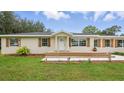 Charming single-story home with front porch and new landscaping at 1518 Lakeside Dr, Deland, FL 32720