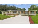 Charming single-story home with a new driveway and well-maintained front yard at 1518 Lakeside Dr, Deland, FL 32720