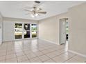 Bright living room with tile floors and a large window offering a view of the front yard at 1610 Brady Dr, Deltona, FL 32725