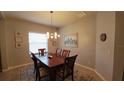 Warm and inviting dining room with modern light fixture, wood table, and an area rug at 1632 Blue Grass Blvd, Deland, FL 32724
