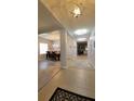 Open-concept hallway featuring neutral paint, decorative lighting, and seamless flow to the dining area and living spaces at 1632 Blue Grass Blvd, Deland, FL 32724