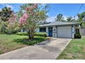 Inviting home featuring a blue front door and a well-maintained driveway at 1828 West Pkwy, Deland, FL 32724