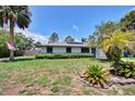 Well-kept single-story home with a manicured lawn and beautiful landscaping at 1828 West Pkwy, Deland, FL 32724