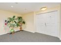 Inviting condo entrance features neutral tones, plants, and double doors for a welcoming arrival at 2 Oceans West Blvd # 305, Daytona Beach, FL 32118