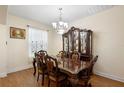 Elegant dining room featuring hardwood floors, a decorative chandelier, and a vintage china cabinet at 218 Wellington Woods Ave, Deland, FL 32724