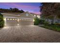 Beautiful home featuring a three-car garage and a brick paved driveway at 227 Blue Crystal Dr, Deland, FL 32720