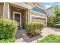 Inviting entryway featuring a brick-paved walkway and a two-car garage with glass window inserts at 2412 Regency Park Dr, Deland, FL 32724