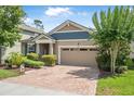 Attractive single-Gathering home with a two-car garage, brick driveway, and neatly landscaped front yard at 2412 Regency Park Dr, Deland, FL 32724