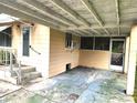 Spacious carport area offering covered parking and additional storage space with a nearby entrance at 2647 Brookline Ave, New Smyrna Beach, FL 32168
