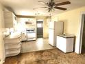 Functional kitchen with white appliances, ample cabinetry, and a ceiling fan at 2647 Brookline Ave, New Smyrna Beach, FL 32168