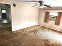 Cozy living room featuring a ceiling fan, window A/C and carpet at 2647 Brookline Ave, New Smyrna Beach, FL 32168