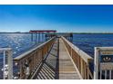 View of the community wooden dock with a covered seating area, great for fishing and relaxing at 2711 N Halifax Ave # 264, Daytona Beach, FL 32118