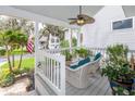Inviting front porch featuring comfortable wicker seating and a charming ceiling fan at 275 Bayou Cir, Debary, FL 32713