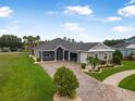 Charming home with a well-manicured lawn, paver driveway, and beautiful landscaping at 2948 Bella Flore Ter, New Smyrna Beach, FL 32168